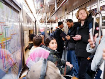 Students and Hub staff riding the NYC subway.